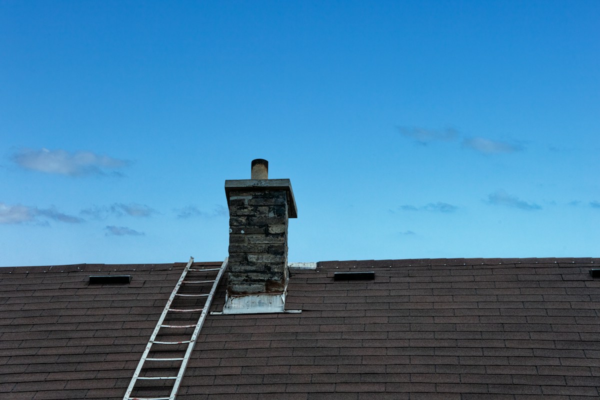 Roof access with ladder beside chimney